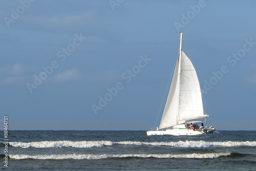 Boat on tropical sea under blue sky