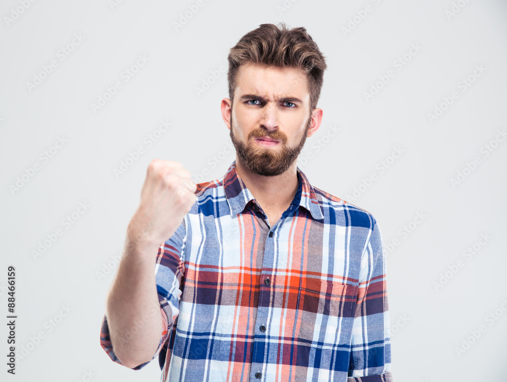 Serious man showing fist at camera Serious man showing fist at camera