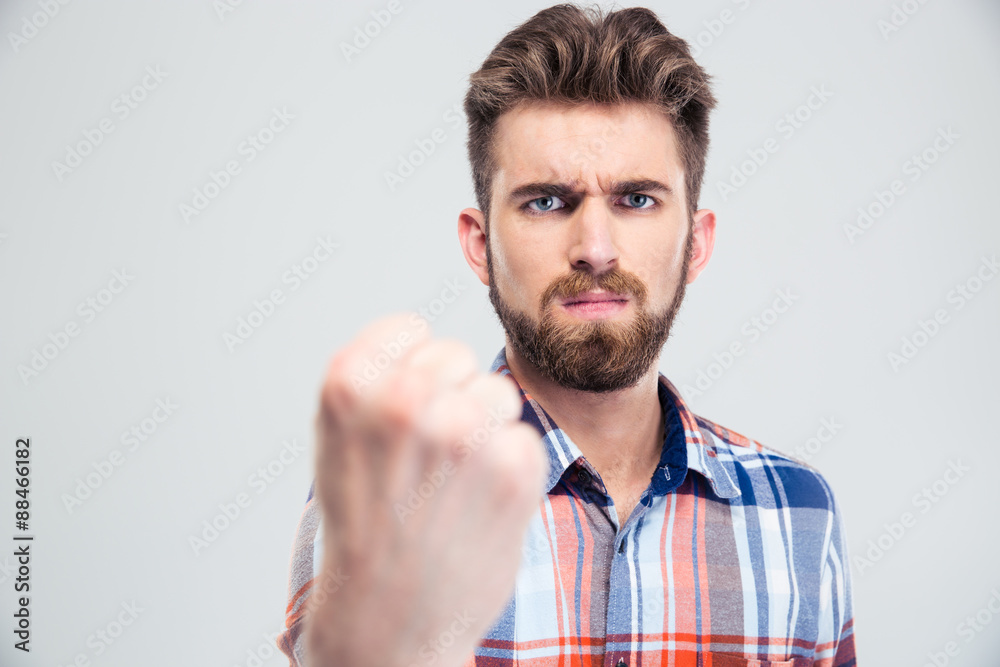 Fototapeta premium Handsome man showing fist at camera