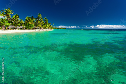 Tropical island in Fiji with beach and water with coral © Martin Valigursky