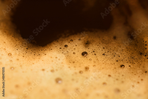 Close up of coffee cup. Isolated espresso foam. Drink morning coffee. Dark coffee foam. Macro image of coffee bubbles. 