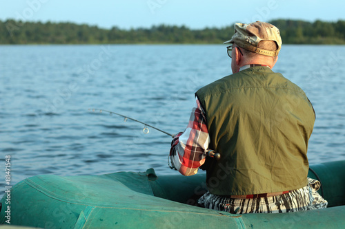 Spinning fisherman on a boat fishing