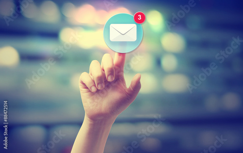 Hand pressing an email icon