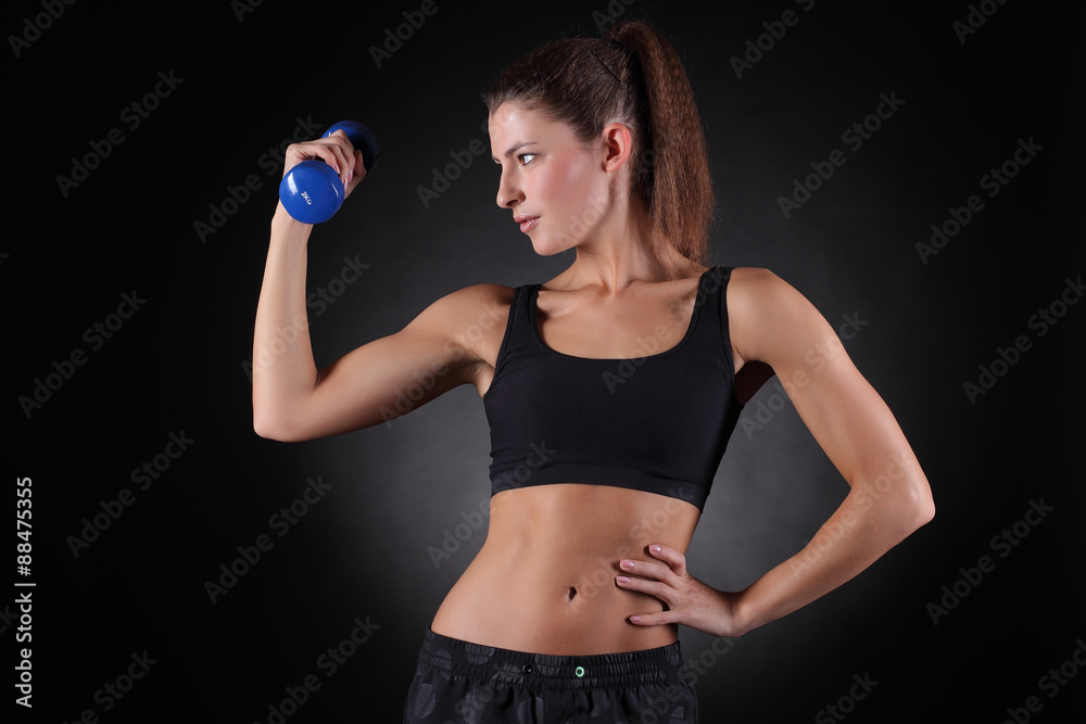 beautiful sporty muscular woman working out with dumbbells beautiful sporty muscular woman working out with dumbbells