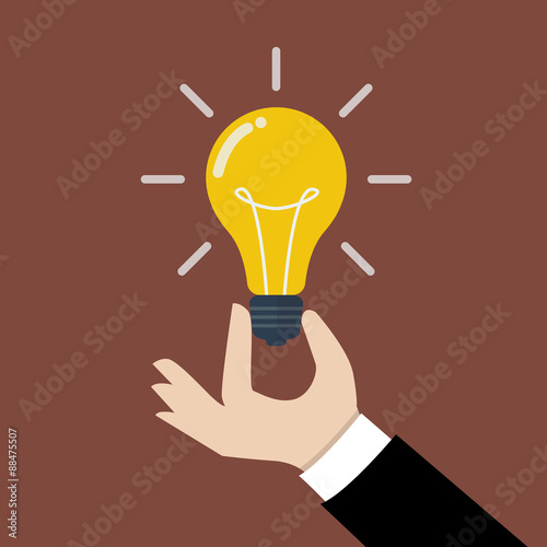 Hand holding light bulb