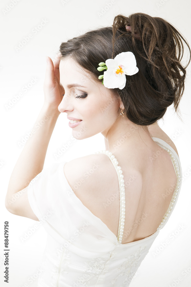 Studio portrait of a young beautiful bride in a white dress