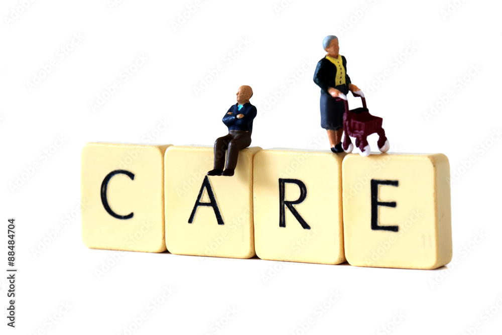 Miniature senior people care.
Miniature scale model senior people on tiles spelling the word care.
