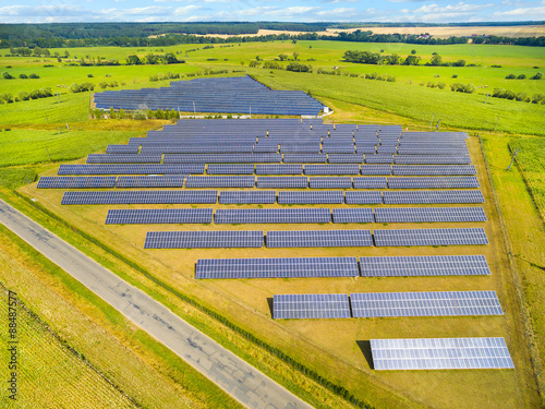 Aerial view to solar power plant. Industrial background on renewable resources theme. photo