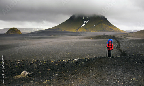 Hiker walking in black desert, Laugavegur trail in Iceland