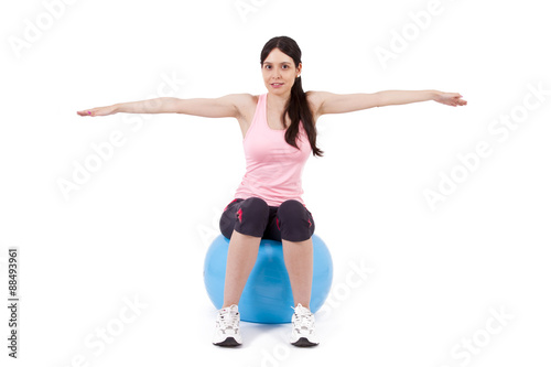 girl doing arm exercises on ball