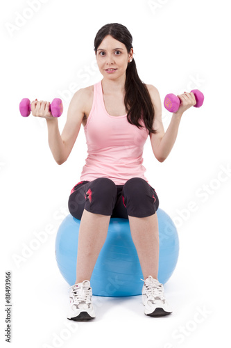 girl lifting weights in gym ball