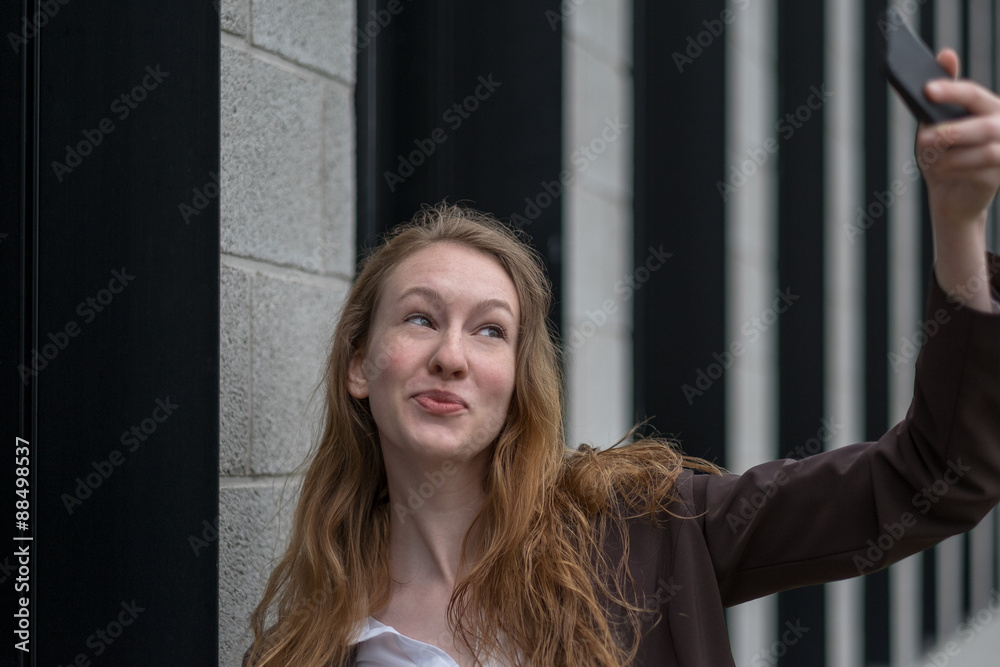 Playful young woman taking a selfie