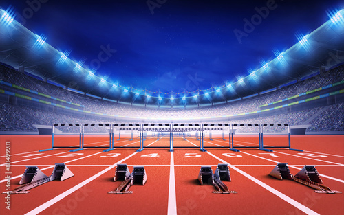 athletics stadium with race track with starting blocks and hurdles photo