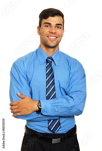 Portrait of young smiling businessman in blue shirt on white background