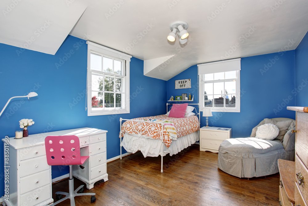 Adorable girls room with deep blue walls.