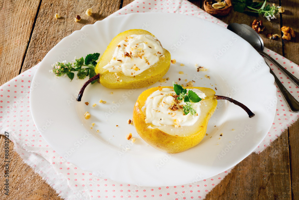 Delicious dessert with pears, sliced halves and curd cream on a Delicious dessert with pears, sliced halves and curd cream on a