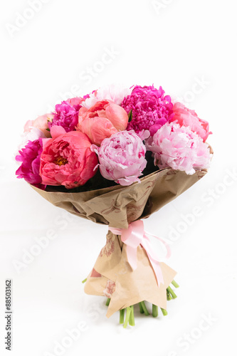 Rich bunch of peonies and tea roses on white background