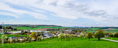 view of small village in luxembourg set among green fields. photo