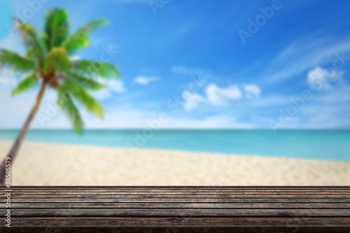 clean wood table beach and palm in background