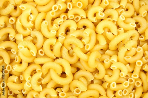 Full background of dry uncooked macaroni pasta