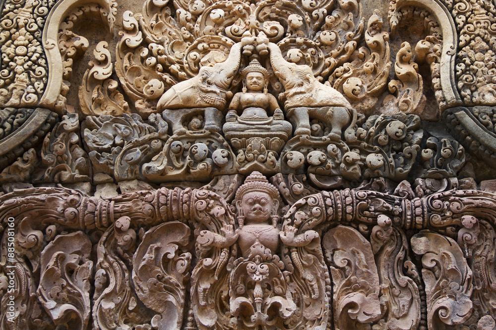 Detail of decoration in Banteay Srei showing elephants and a figure of the Buddha.near Seim Reap, Cambodia