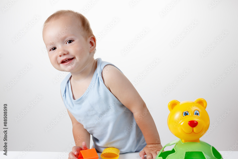 Baby play with toy in blue dress smiling Baby play with toy in blue dress smiling