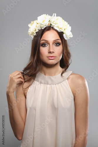 Portrait of a beautiful woman with flowers in her hair. Fashion