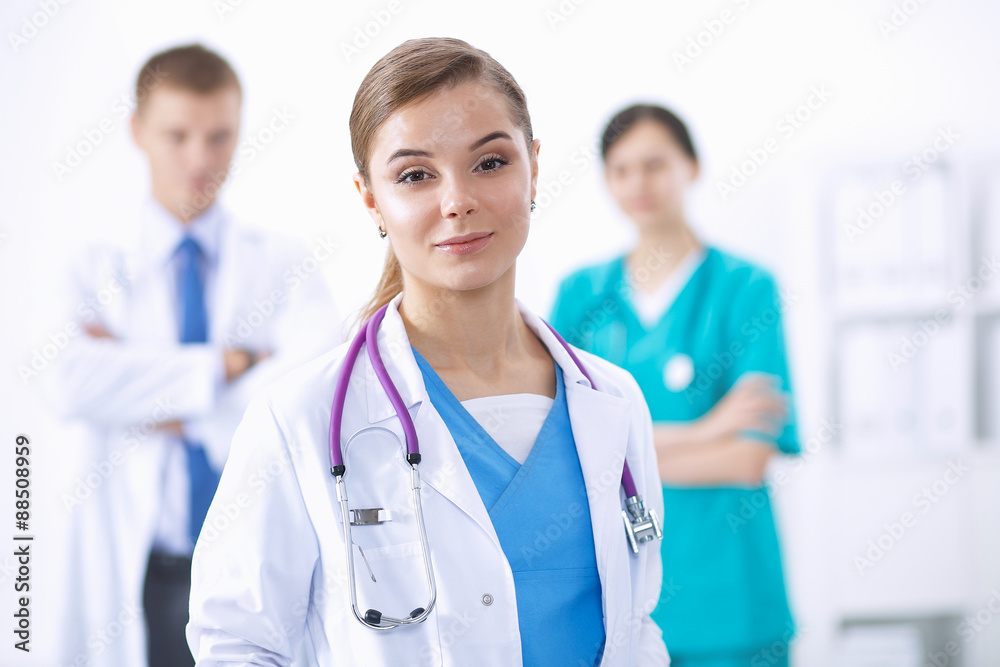 Attractive female doctor in front of medical group Attractive female doctor in front of medical group