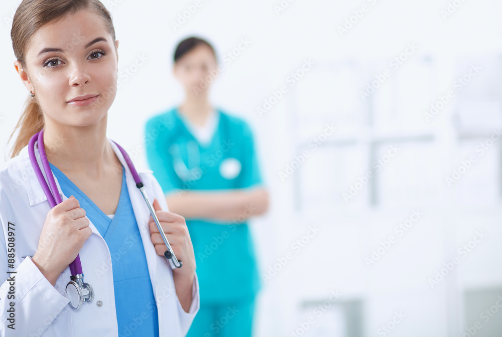 Woman doctor standing with stethoscope at hospital Woman doctor standing with stethoscope at hospital