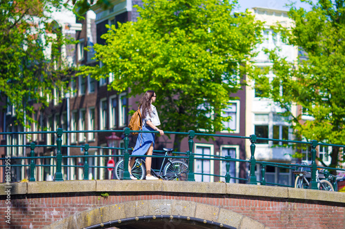 Canvas Print Young beautiful woman walking in european city, Amsterdam