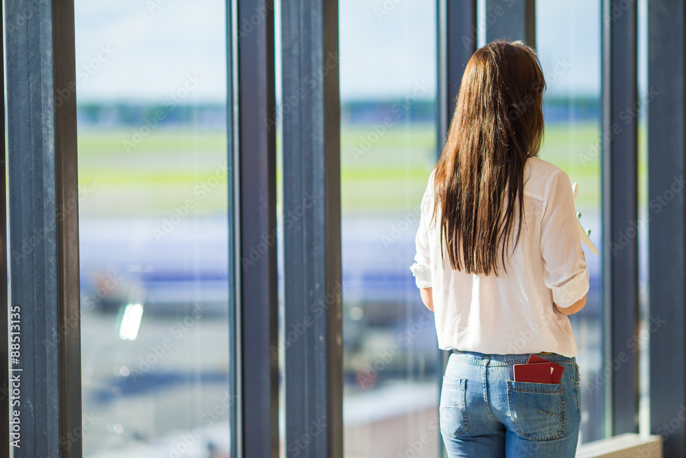 Happy girl with air ticket and passports at airport waiting for Happy girl with air ticket and passports at airport waiting for