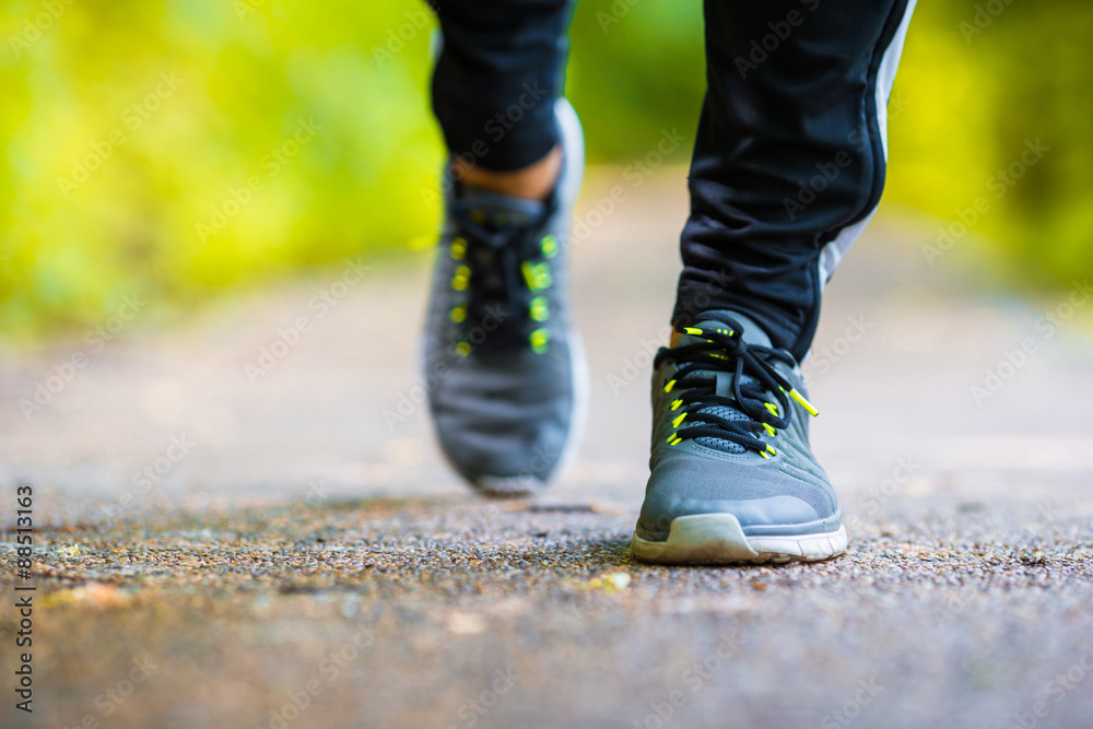 Close-up on shoe of athlete runner man feet running on road 