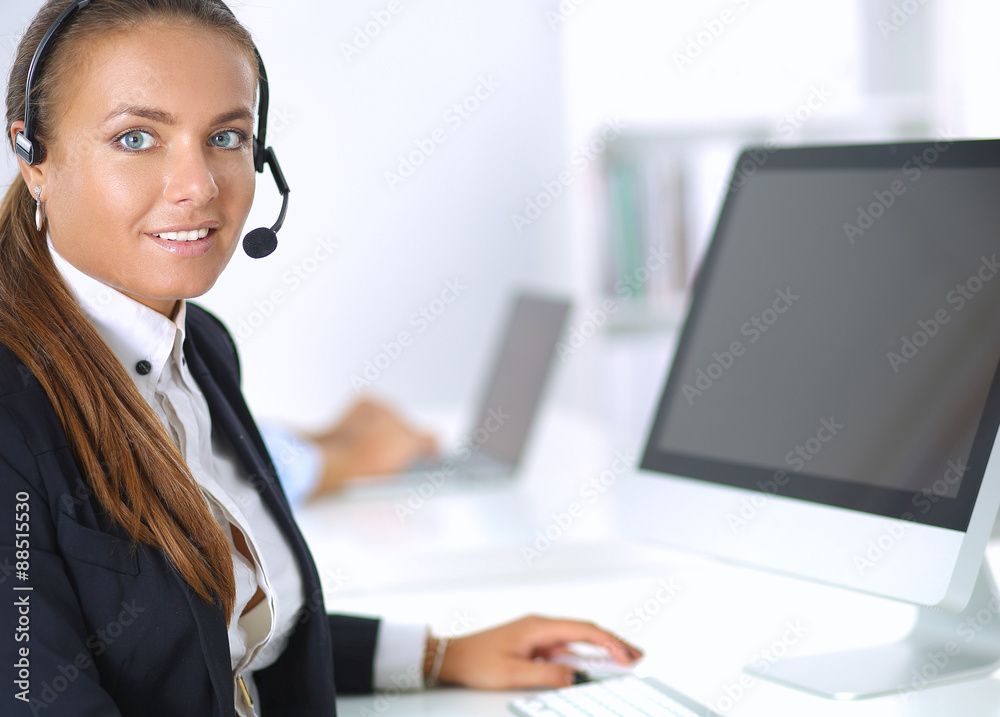 Happy female wearing headset and sitting on the desk Happy female wearing headset and sitting on the desk