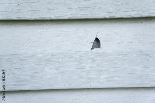 Hail Damage On Vinyl Siding Of A House
