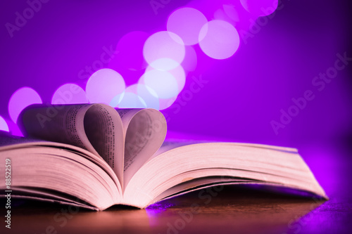 Book with low light and pink bokeh