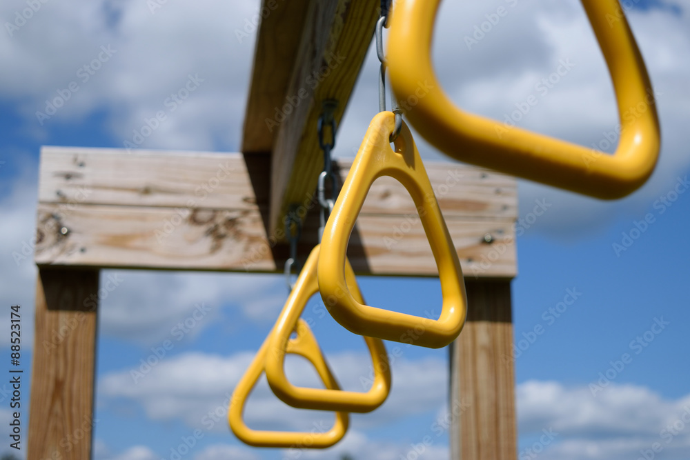 View from below of monkey bar rings hanging from wooden playset beam Stock  Photo | Adobe Stock
