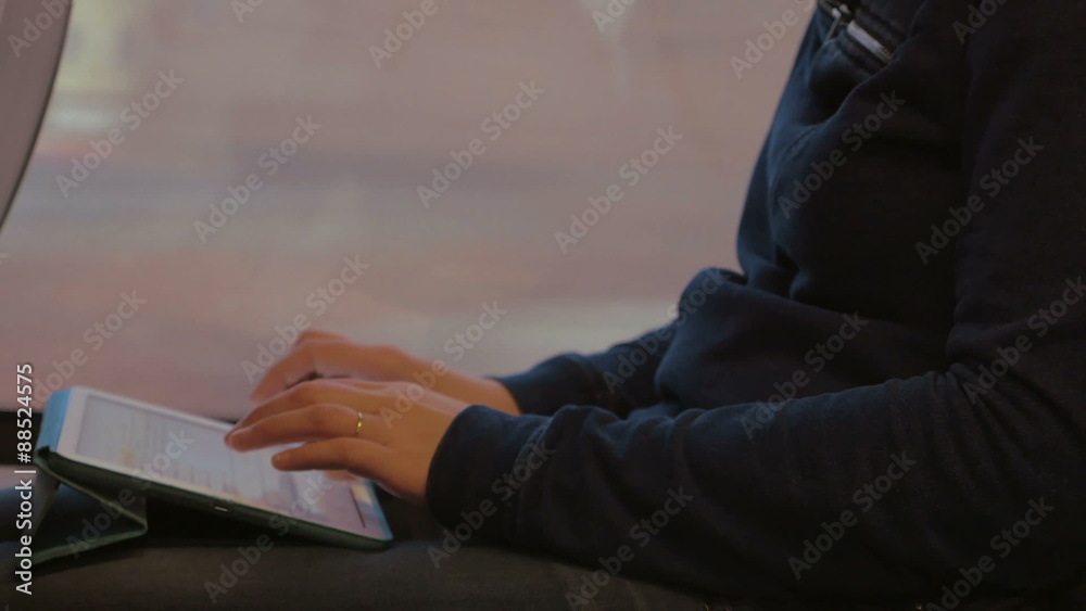 Woman Writing on Tablet PC during the Trip Woman Writing on Tablet PC during the Trip
