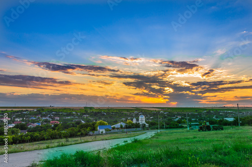 Bild auf Leinwand Sunset over village