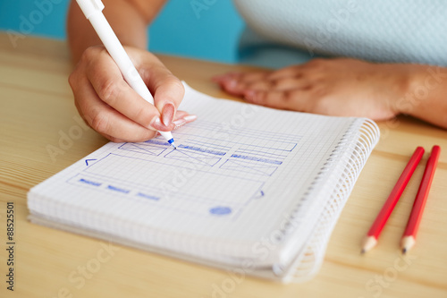 Woman sketching web design in office