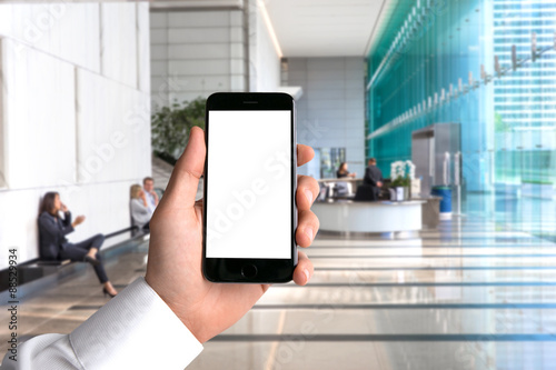 Foto Blank card cell phone smartphone hand POV business man background workplace offi
