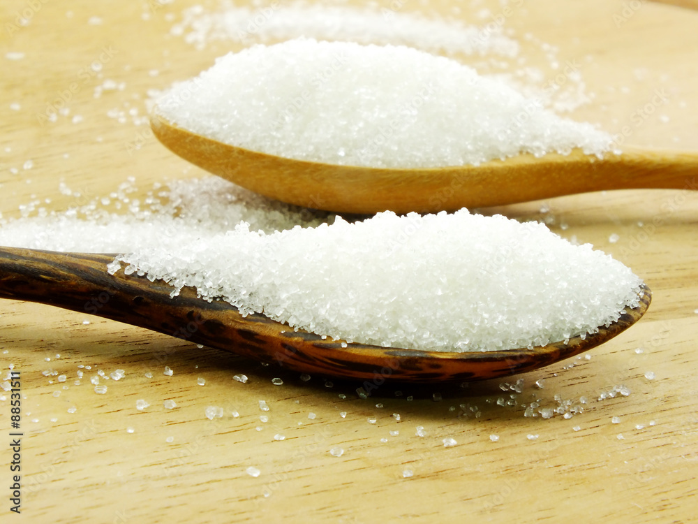 sugar in a wooden spoon selective focus sugar in a wooden spoon selective focus