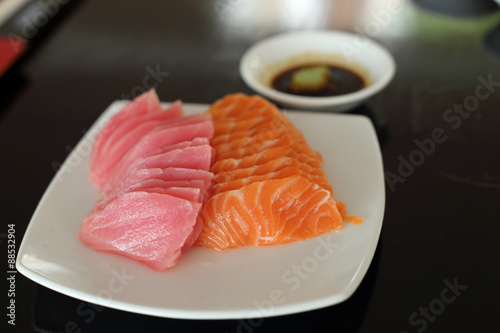 salmon and maguro sashimi on white dish.