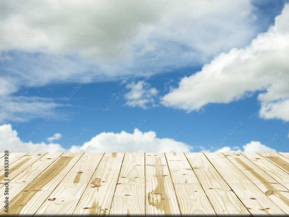 Wood table top on blue sky and cloud blurred background Wood table top on blue sky and cloud blurred background