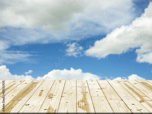 Wood table top on blue sky and cloud blurred background