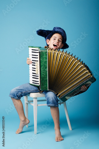 little accordion player on blue background