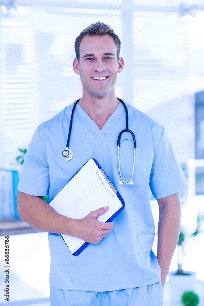 Smiling doctor holding a clipboard Smiling doctor holding a clipboard