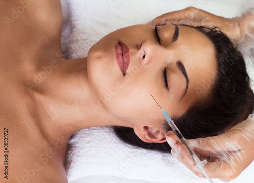 Young woman receiving cosmetic injection