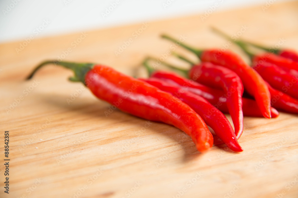   fresh raw red hot chili peppers on wood