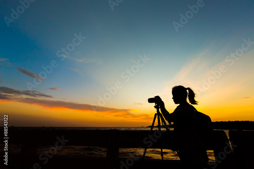 Fototapeta Naklejka Na Ścianę i Meble -  Silhouette of photographer at sunset.
