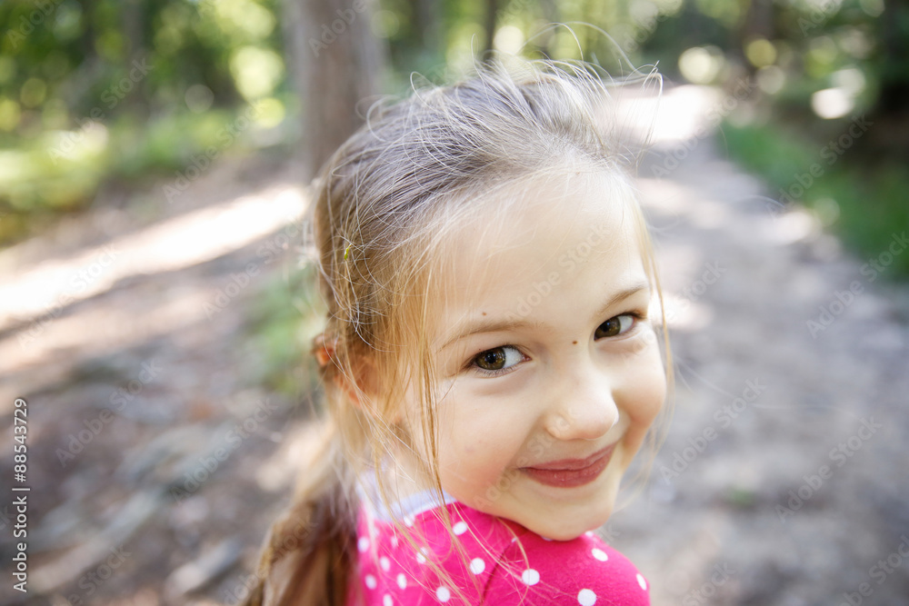 Little girl enjoying a hike through the woods